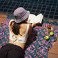 A woman lays on the Butterfly - Dark Slate sarong from YUMI & KORA by the pool. Our sarongs can be used as a pool towel or as a beach towel