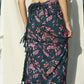 A woman wears the Butterfly - Dark Slate sarong from YUMI & KORA as a skirt. Our sarongs can be tied into a sarong skirt or a sarong dress. Our sarongs work great as a swimsuit coverup