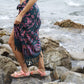 A woman wears the Butterfly - Dark Slate sarong from YUMI & KORA as a skirt. Our sarongs can be tied into a sarong skirt or a sarong dress. Our sarongs work great as a swimsuit coverup