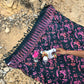 The Butterfly - Dark Slate sarong from YUMI & KORA is used as a picnic blanket by the beach