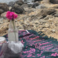 The Butterfly - Dark Slate sarong from YUMI & KORA is used as a picnic blanket by the beach