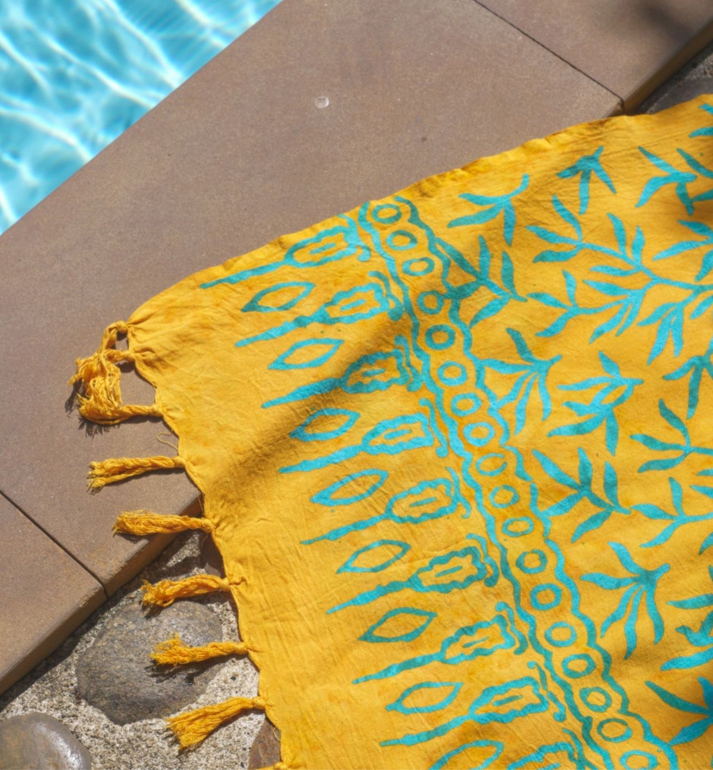 The Lanta Reef - Yellow sarong from YUMI & KORA is used as a pool towel by the pool