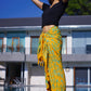 Woman wearing the Lanta Reef - Yellow sarong from YUMI & KORA as a wrap skirt or swimsuit cover up at the pool