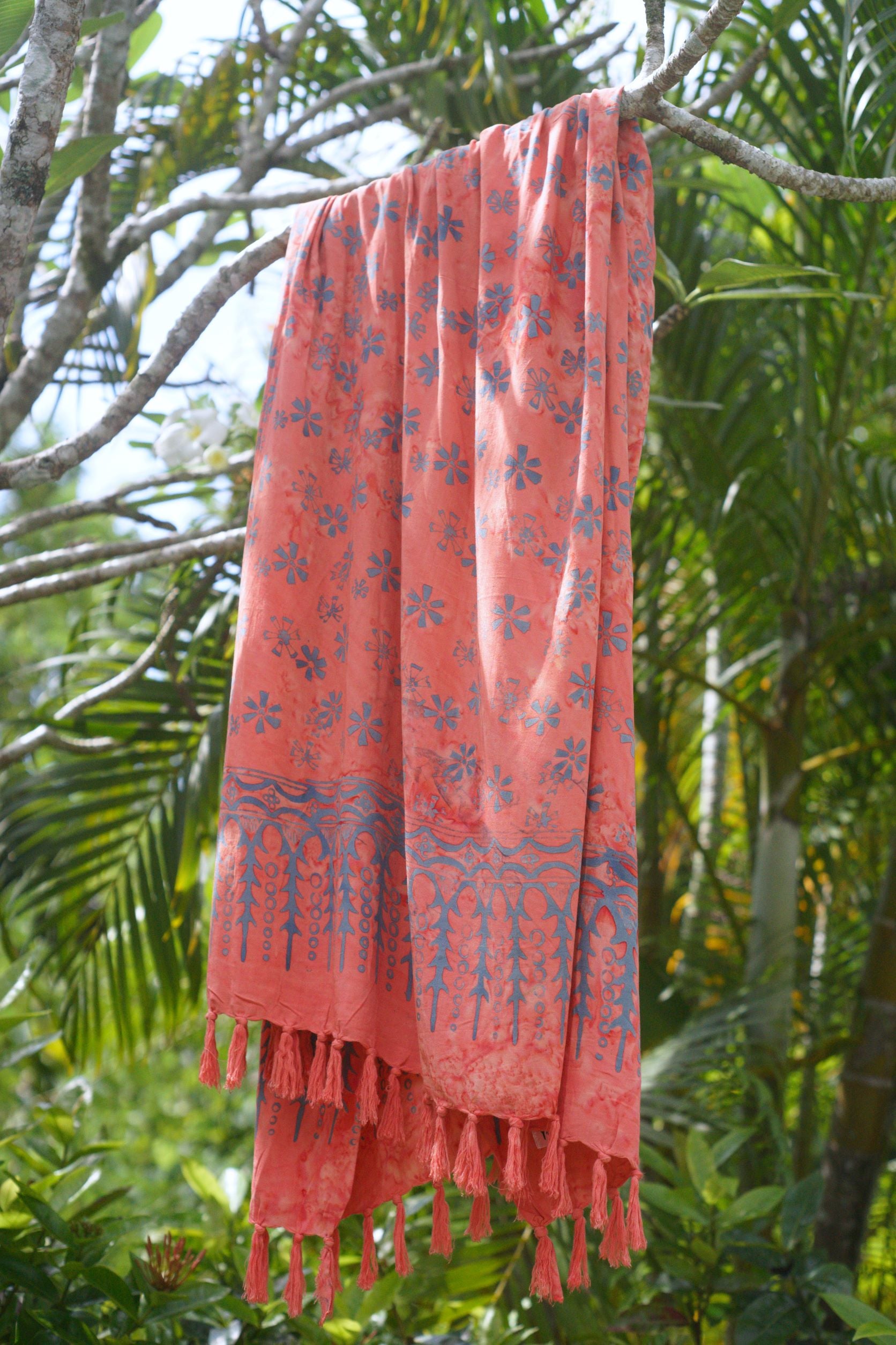 The Sweet Cosmos - Pink sarong from YUMI & KORA hangs from a tree branch