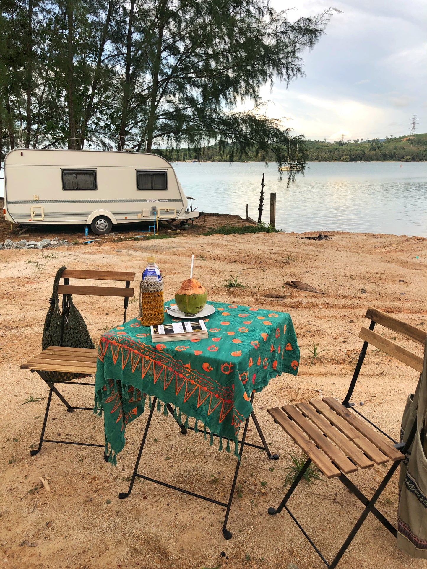 The Tropical Dream - Teal sarong from YUMI & KORA is used as a table cover at a campground by the sea